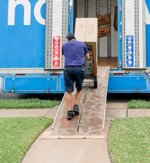 a member of Bernd Moving and Storage loading items in a truck